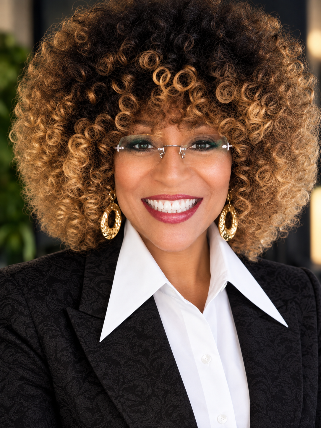 Allison Kalloo smiling in a black jacquard jacket and white shirt